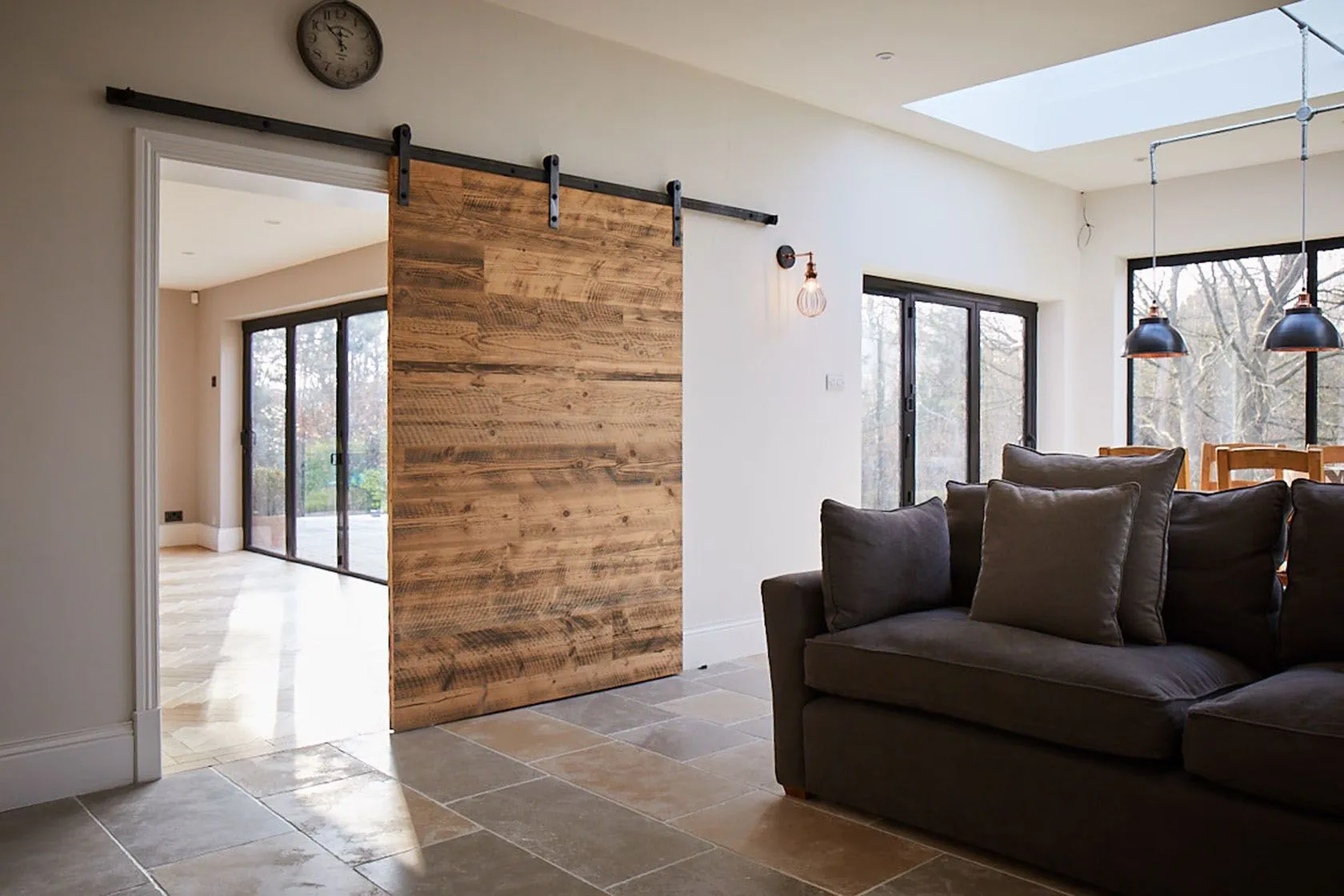 A barn door crafted from raw metal, exuding industrial vibes in a loft-style apartment.