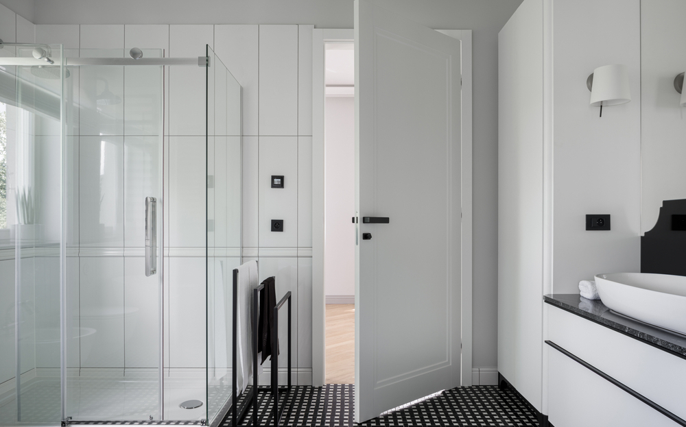 Stylish wooden bathroom door featuring frosted glass panel for privacy.