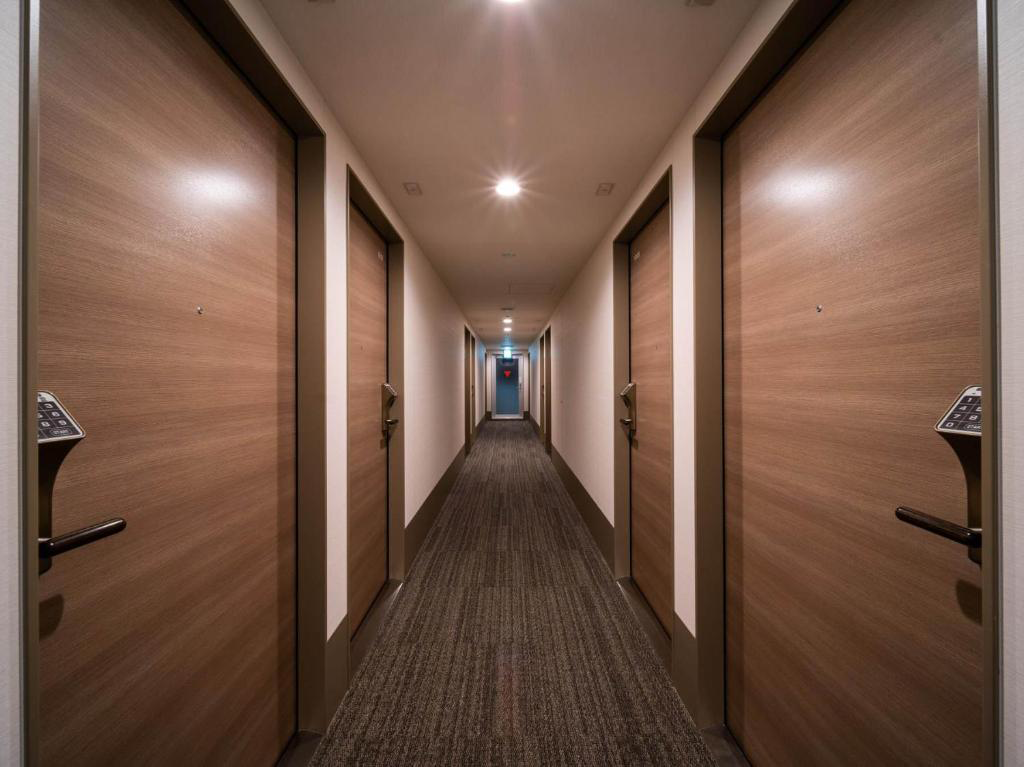 Emergency exit equipped with a certified hotel fire door and panic bar for guest safety during emergencies.