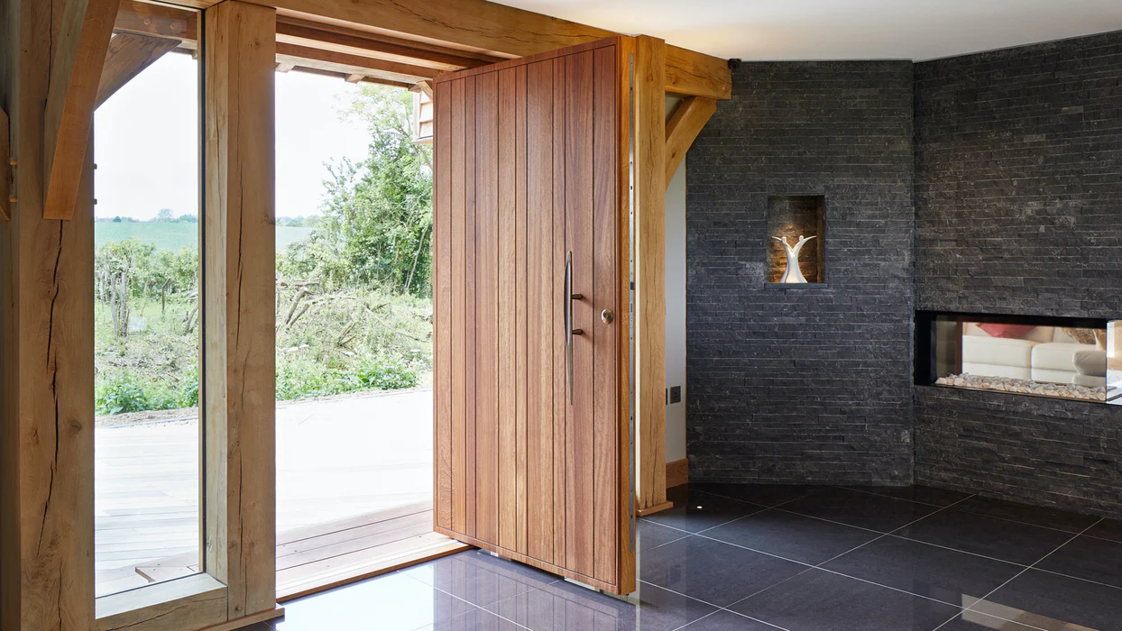 Elegant pivot door in a matte black finish, providing a bold and stylish entrance to a commercial building.
