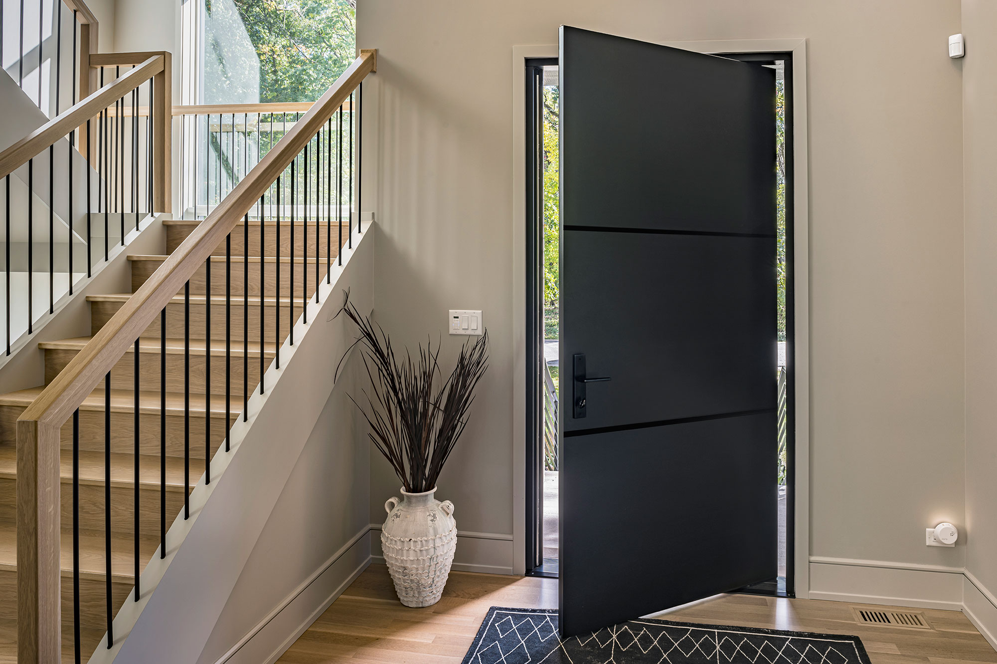 Exterior pivot door with a weather-resistant coating, ensuring durability and style in any climate.